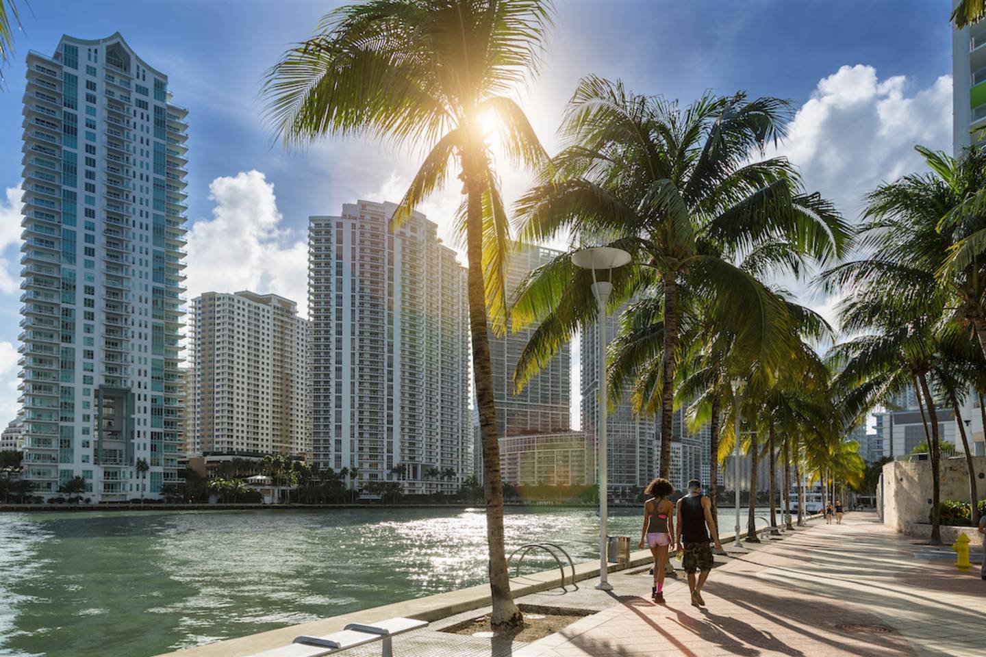 People walking along the Miami River.