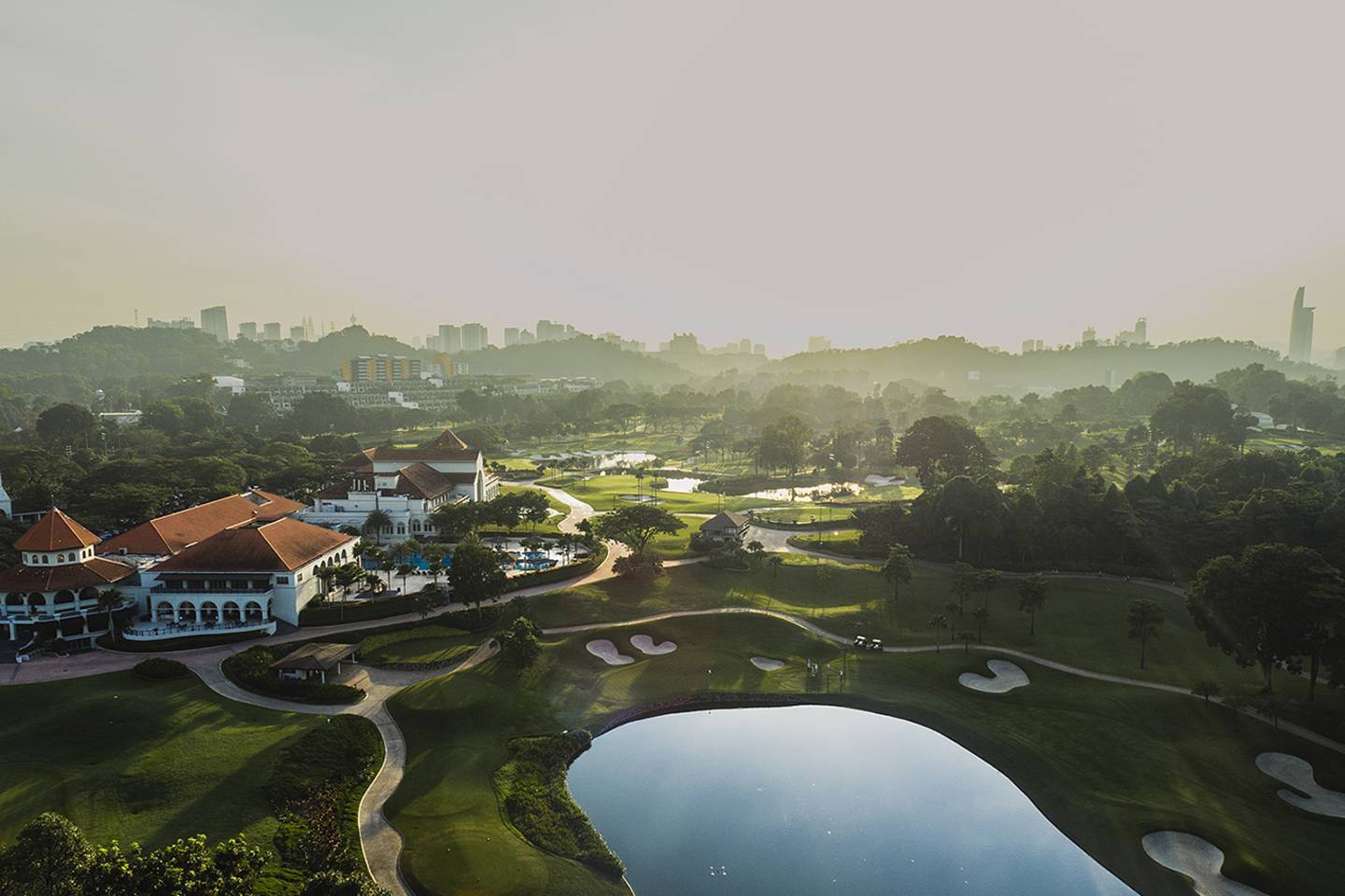 aerial view of golf course with pond